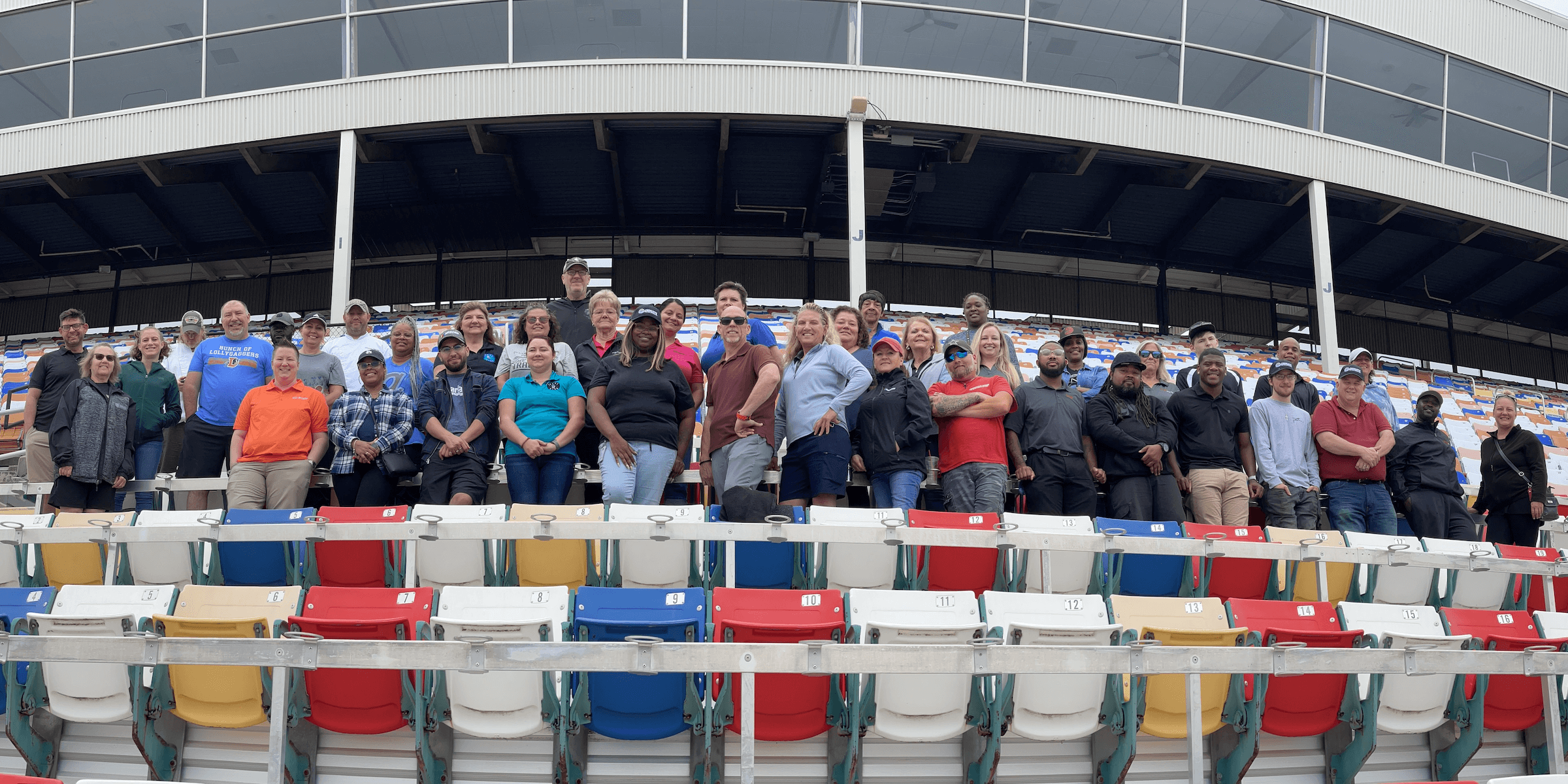 A group of employees in the stands of a stadium - Desktop Version