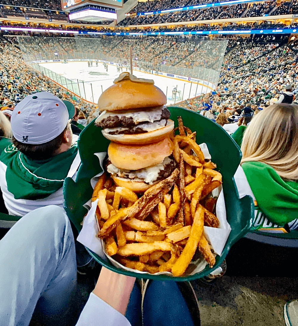 double burger and fries in front of hockey rink