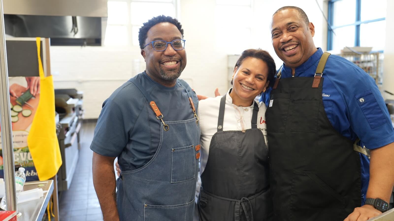 Three chefs smiling
