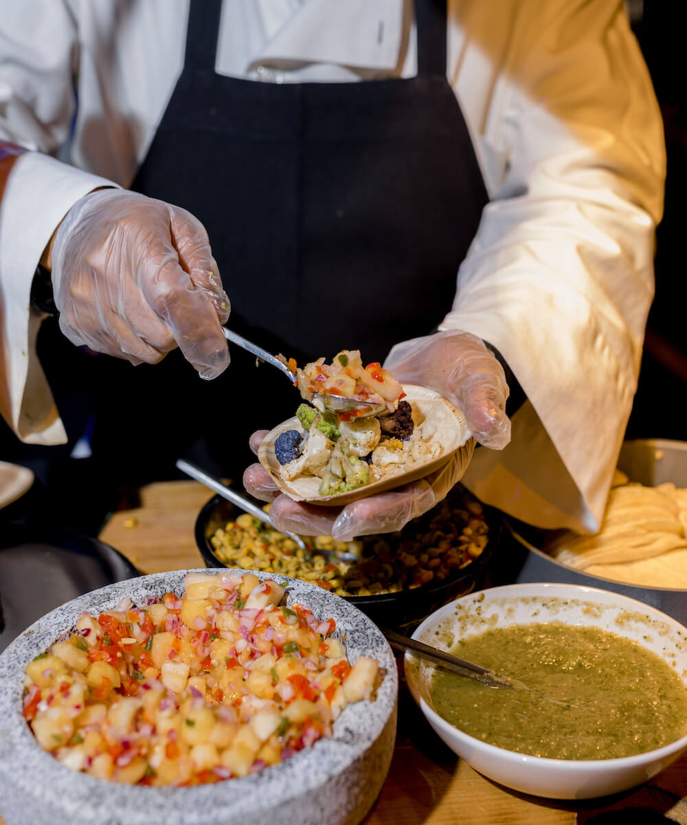 chef hands plating tacos