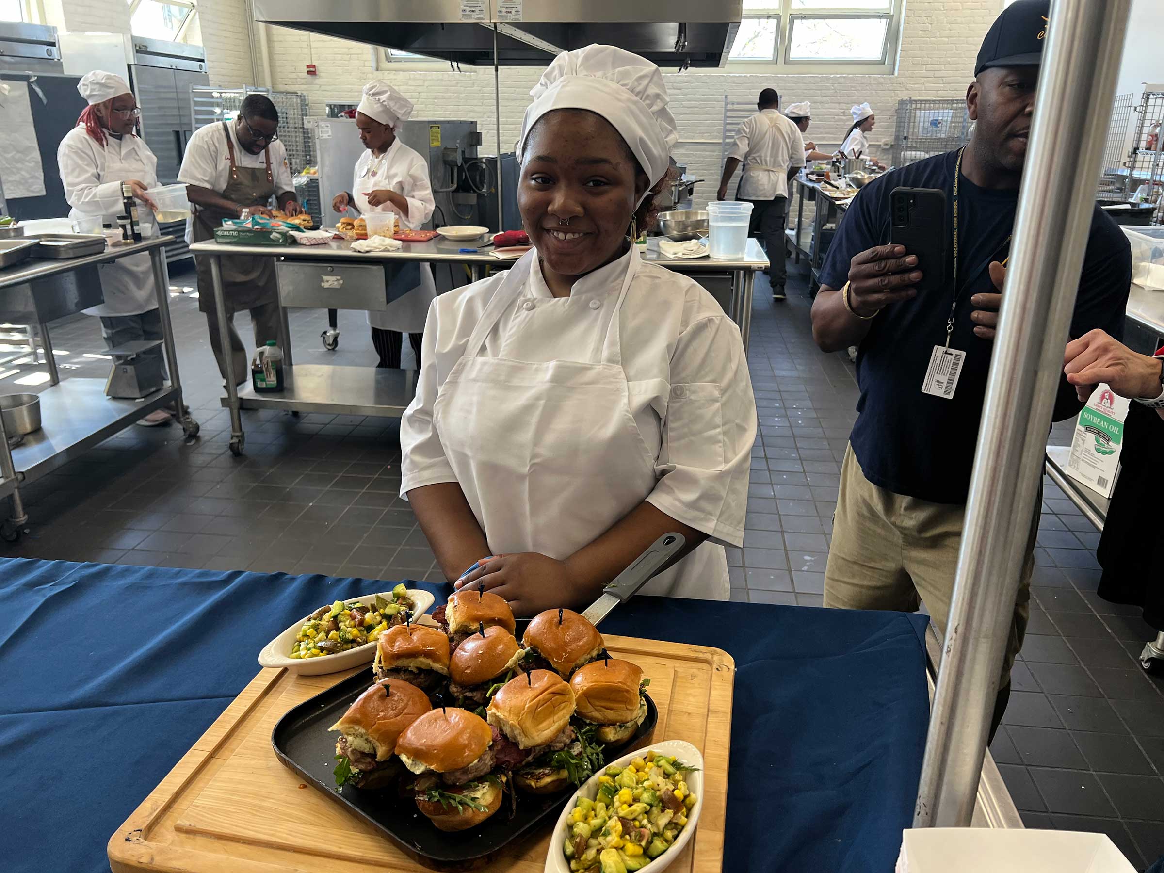 A Chicago Vocational High School student presenting her dish