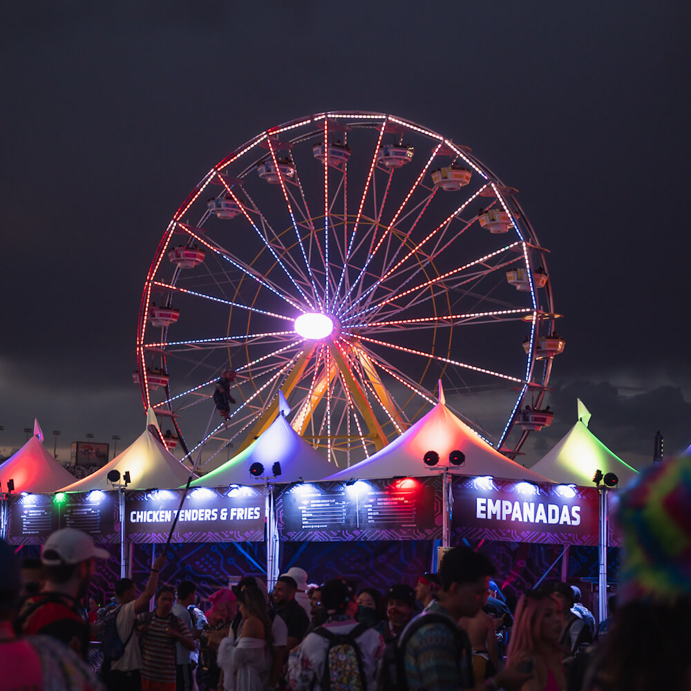 food tents at a festival with a ferris wheel