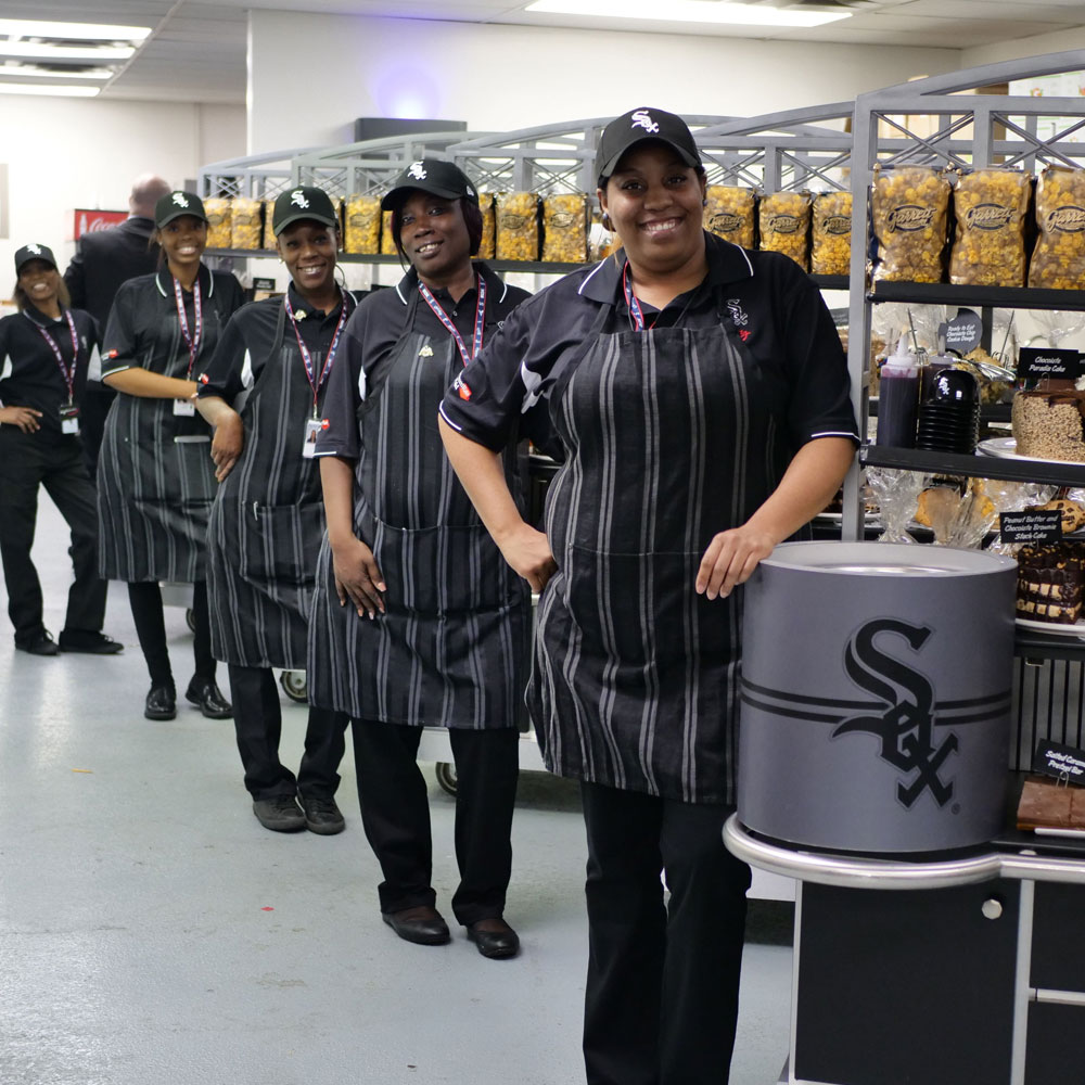 A line of smiling servers at White Sox stadium
