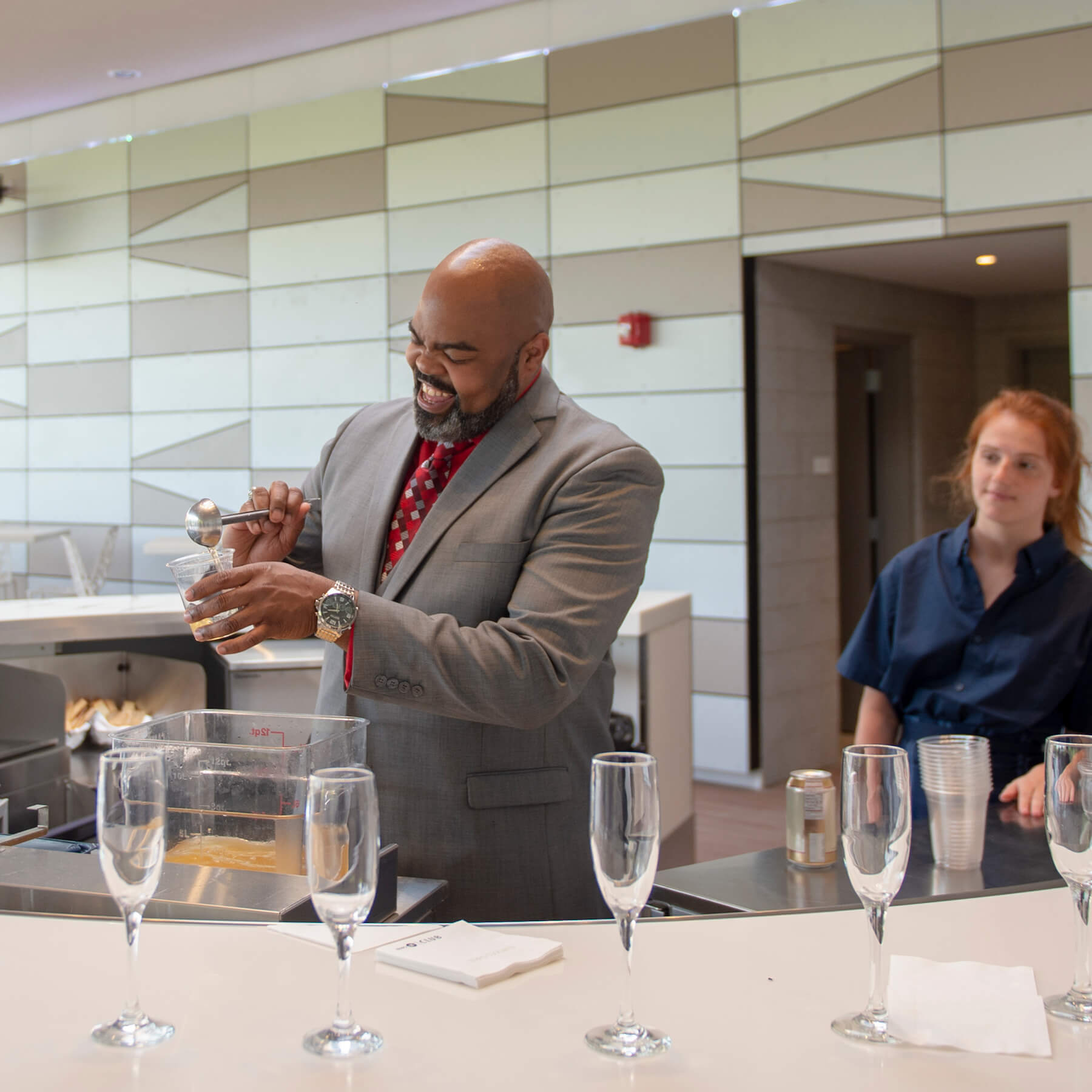 happy bartender pouring a drink