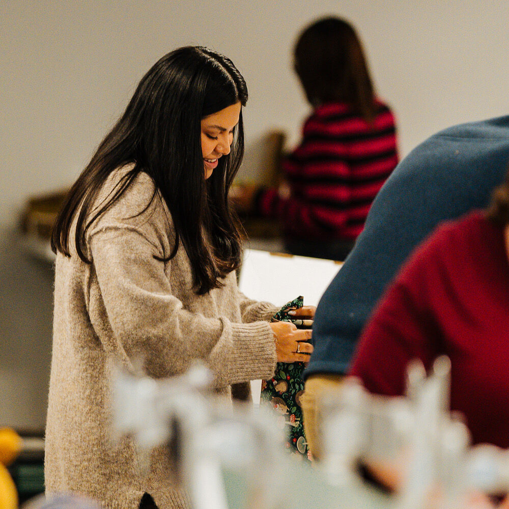 team member wrapping a present