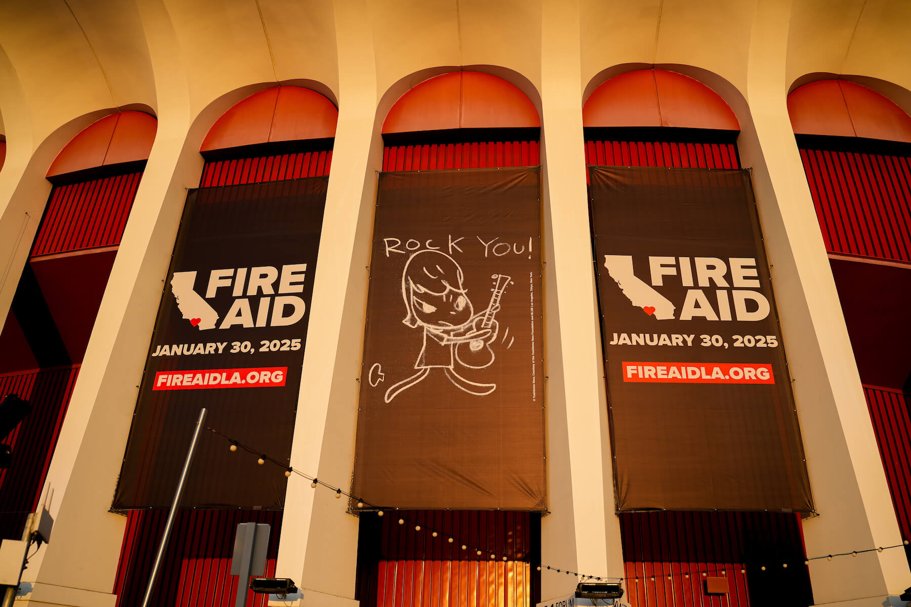 Fire Aid signs at Kia Forum