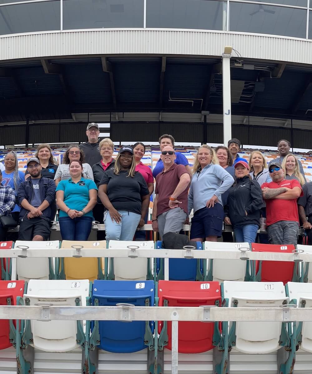 A group of employees in the stands of a stadium - Mobile Version