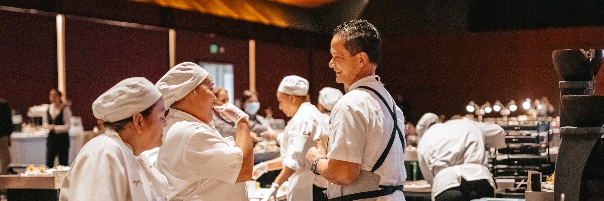 chefs laughing while prepping food - Desktop