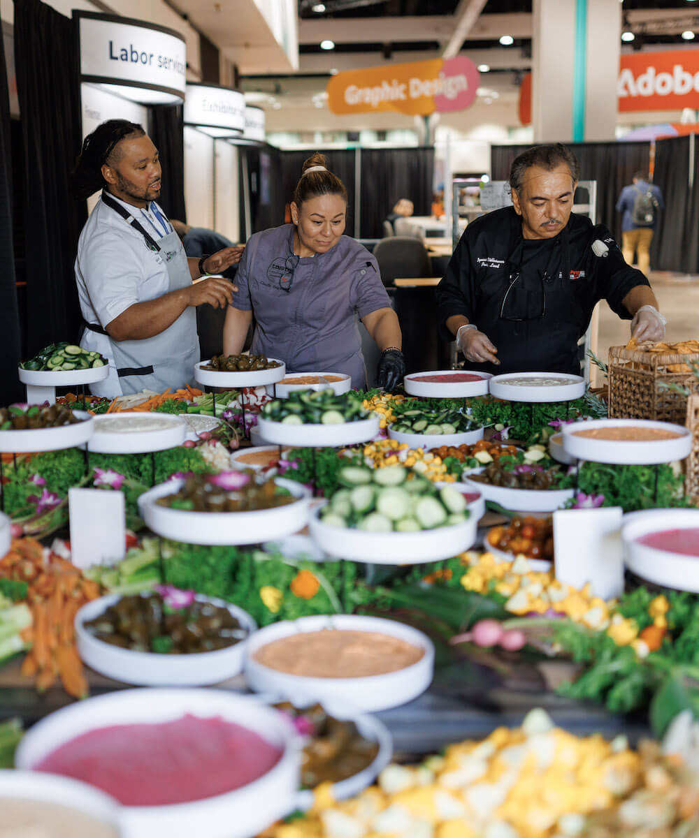 three levy team members organizing food - Mobile