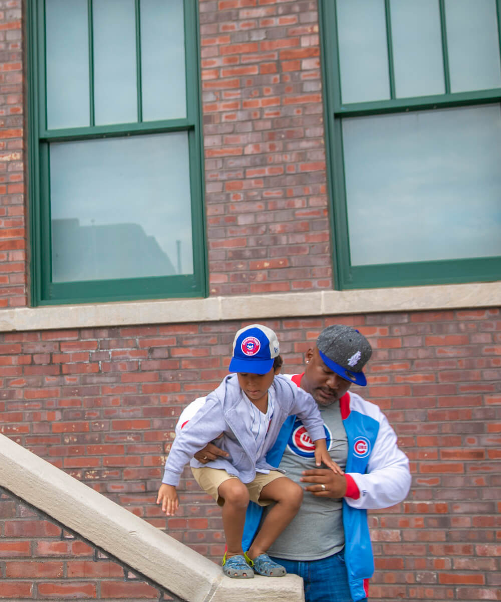 two cubs fans in cubs merchandise - Mobile