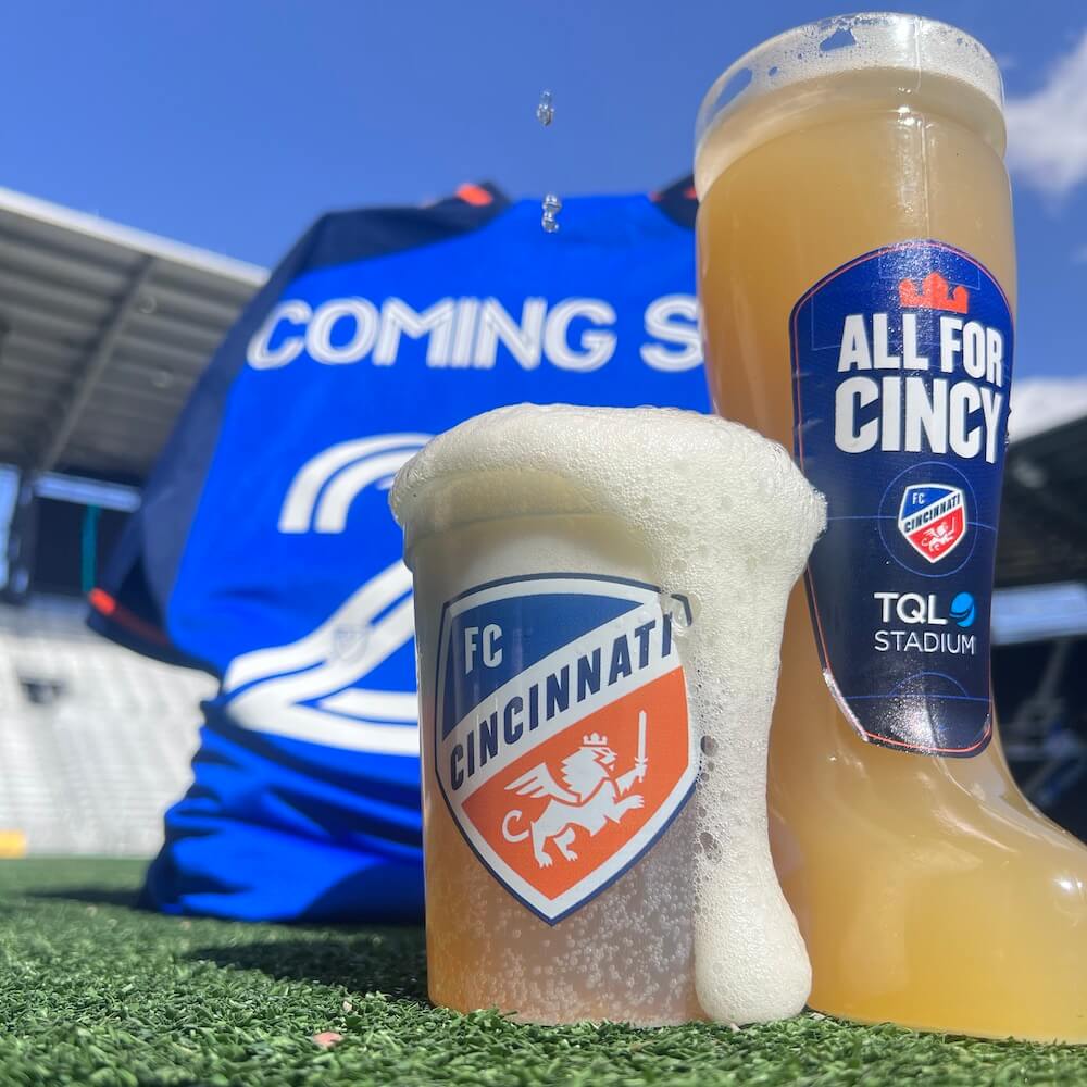 beer cup and beer boot and soccer jersey on a soccer field