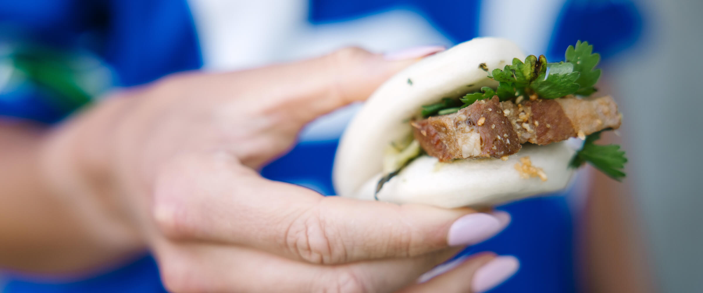 woman holding a bao bun - desktop version