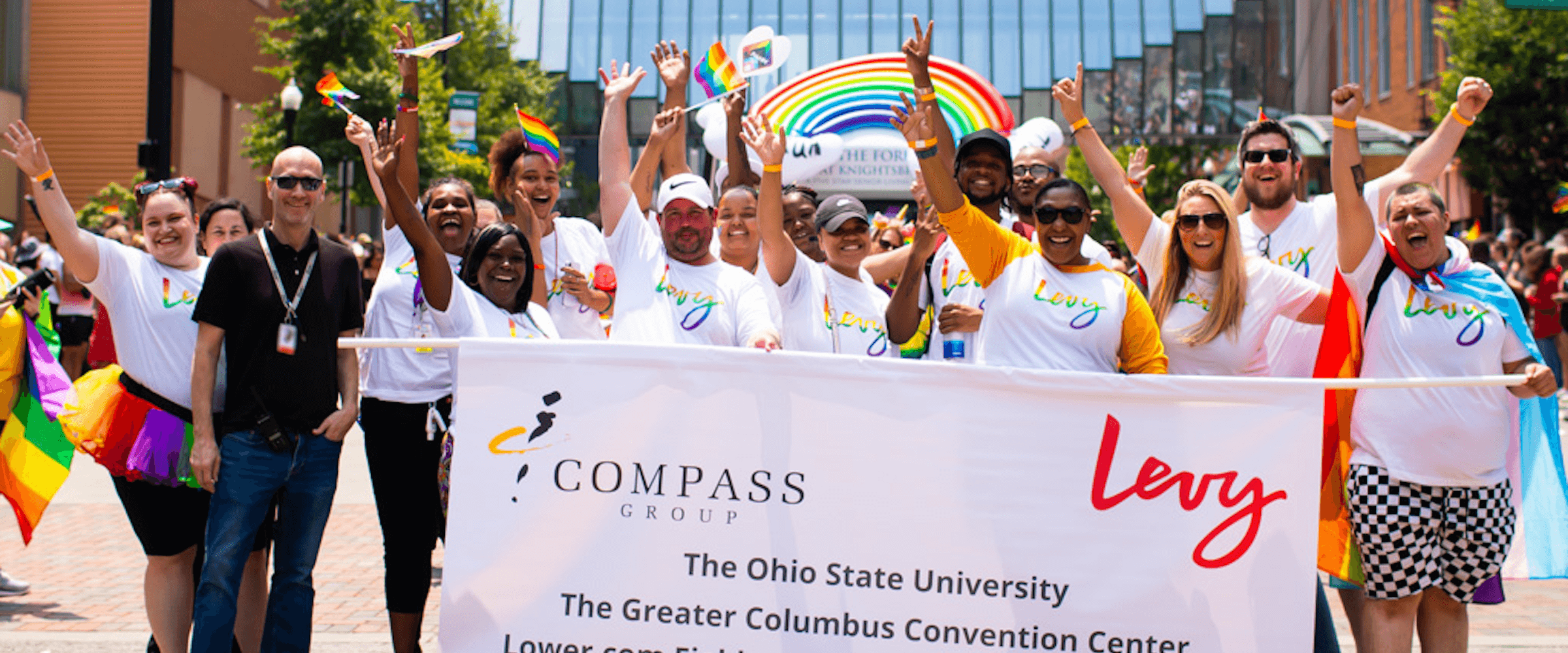 levy team marching in pride parade - desktop version